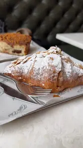 A montage-style video showcasing the interior, menu, and food offerings of Paragon Coffee Club in Glasgow. The video highlights the cozy decor, coffee, and pastries, with shots of the exterior and interior details.