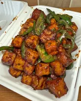 Delicious Indo-Chinese takeaway: chilli paneer, crispy aubergines, and veg manchurian from Tangoe Restaurant in Leicester.