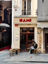 Here are a few options, keeping the 125-character limit and SEO in mind, assuming the image shows a stylish coffee shop from the list:

**Option 1 (Focus on interior):**
Chic Parisian coffee shop interior, one of 10 highly recommended cafes in a Paris travel guide for coffee lovers. (118 characters)

**Option 2 (More general):**
Vibrant Parisian coffee shop scene, representing one of 10 best cafes in a Paris guide for your next visit. (110 characters)

**Option 3 (Emphasizing the list):**
Beautiful Parisian coffee shop, showcasing one of 10 must-visit cafes from a Paris travel guide. (107 characters)