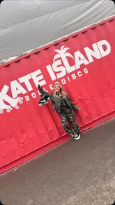 Vibrant scene at Skate Island Newcastle: people roller skating on an outdoor rink, enjoying the beach, food vendors, and music.