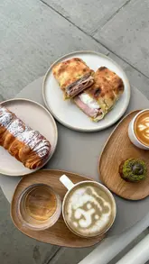 A montage-style video showcasing 60 Degrees Coffee in Victoria, London. The video features shots of the cafe's exterior and interior, a display of pastries and sandwiches, the menu board, the coffee preparation process, and a final shot of a table spread with coffee and food.