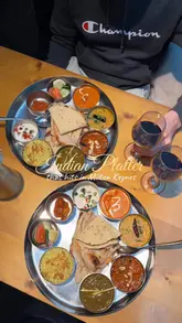 Maaya Special Thali platter with butter chicken, garlic chilli chicken, tadka dal, and paratha at Maaya Indian Kitchen in Milton Keynes.