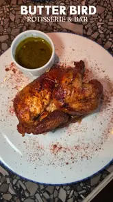 A promotional review of Butter Bird, a rotisserie chicken restaurant in Ancoats, Manchester. The video features a tour of the interior, a look at the rotisserie cooking process, and a close-up showcase of various sides and the main chicken dishes.