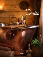 Cozy Quabbs Cabin in Mid Wales with a hot tub overlooking the picturesque natural landscape, perfect for a peaceful escape.