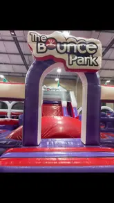 A fast-paced, handheld video tour of an indoor inflatable park, featuring a child navigating various obstacles, slides, and climbing zones. The video captures the high-energy atmosphere of the venue, focusing on the physical activities available for children.