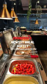 Diners at the Hot World Cuisine halal buffet in Edinburgh, featuring various international dishes and a spacious restaurant interior.