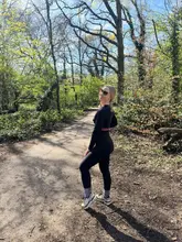 Smiling hiker enjoys beautiful Hampstead Heath views of London, celebrating recovery on a sunny walk.