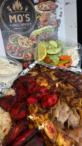 A review of Mo's Grill House in Swansea, highlighting their homemade marinades, diverse menu including Turkish and Indian dishes, and friendly service.