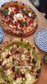 A short, engaging review of Leopardo Pizza in Glasgow, featuring close-ups of their pepperoni and prawn & nduja pizzas, along with their signature dips. The video highlights the restaurant's atmosphere and the quality of the food.