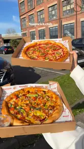 A short video showcasing various food items from Naanwich Club, including butter chicken pizza, wraps, and chilli chicken bites, filmed from a car and outside the venue's stall.