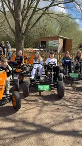 A promotional video for Nature Buggies, featuring groups of friends and families riding pedal-powered buggies through a woodland park. The video includes shots of the price list, the buggies in action, and the participants having fun.