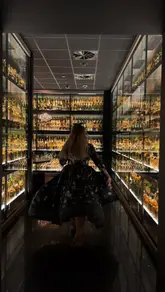 A short, slow-motion clip featuring a creator walking through the Diageo Claive Vidiz Collection at The Scotch Whisky Experience in Edinburgh, showcasing the extensive whisky display.