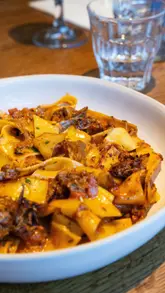 A montage video showcasing the interior, menu, and food offerings of The Chequers, a gastropub. The video features shots of the dining area, bar, and various dishes including a scotch egg, steak, and pasta, set to music.