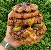 Double-stacked buttermilk fried chicken, maple bacon, gherkins, pearl-sugar waffle, and Biscoff Caramel Chili sauce.