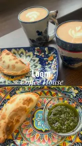 Here are a few options for your SEO alt text, keeping under the 125-character limit:

**Option 1 (Focus on food/brand):**
Latte, cappuccino, empanadas, and a white chocolate alfajor on a wooden table at Loom Coffee House in Glasgow.

**Option 2 (Descriptive & cozy):**
A cozy coffee spread with lattes, vegan tamales, and alfajores at Loom Coffee House on Maryhill Road, Glasgow.

**Option 3 (Concise):**
Guatemalan coffee and fresh empanadas served at Loom Coffee House in Maryhill, Glasgow.

**SEO Tip:** I recommend **Option 1 or 2** as they include the specific items (coffee and food) which helps with Google Image search rankings for those keywords!