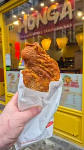 A short video showcasing Taiwanese fried chicken and bubble tea from Monga, featuring shots of the shop exterior, interior, and close-ups of the fried chicken and drinks.