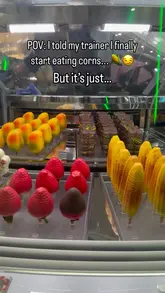 Close-up of Snowflake Gelato's Snowcob sweetcorn & vanilla gelato shaped like corn on the cob, beside Ube drinks.