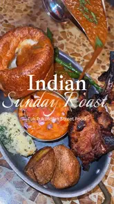 A promotional video for Tuk Tuk Indian Street Food featuring their new Indian-style Sunday Roast menu. The video showcases various dishes including lamb chops, chicken tikka, and paneer, served with traditional roast trimmings and Indian gravies. It also highlights the lively atmosphere with a dance performance.