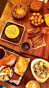 A promotional video for Hickory's Smokehouse featuring a tour of the venue, including the outdoor play area, cinema room, bar area, and a variety of their signature BBQ dishes and drinks.