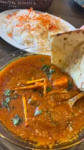 A spread of authentic Pakistani food: paneer curry, chicken curry, pilau rice, naan, lamb seekh kebab, peri peri wings, masala fries, salad.