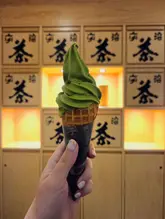Vibrant green matcha soft serve ice cream presented in a cup, a beloved treat from Tsujiri UK.