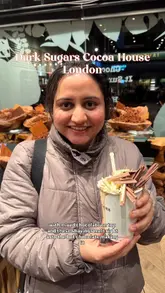The video features a visit to Dark Sugars Cocoa House in London, highlighting the extensive variety of chocolates available and the signature hot chocolate preparation, which involves shaving large amounts of chocolate directly into the cup.