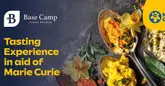 A professionally shot promotional graphic for a charity tasting menu event at an Indian restaurant. The image features a flat-lay composition of spoons containing Indian dishes, garnished with flowers and spices, set against a dark, textured background.