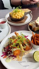 Two creators visit a garden centre, showing the retail space and the cafe menu. They highlight specific dishes like haddock tacos, mac and cheese, and french toast.