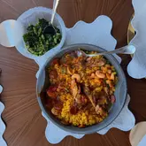 M&S DINE IN paella, greens, and mac and cheese croquettes served as a quick, delicious dinner at home.
