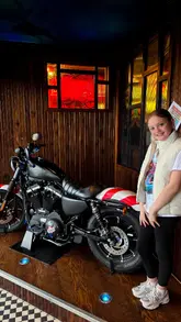 A montage video showcasing a visit to TGI Fridays, highlighting the 'Kids Eat Free' offer, the American diner-style decor, and various food items including a burger, chicken, and a build-your-own sundae.