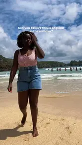 Here are a few options for your SEO alt text, keeping it under 125 characters:

**Option 1 (Descriptive):**
A woman enjoying a sunny day at a beautiful, sandy beach in Cornwall, England during a summer trip.

**Option 2 (Travel-focused):**
Scenic view of a golden sandy beach in Cornwall, UK, perfect for a summer travel destination.

**Option 3 (Concise):**
Relaxing at a stunning beach in Cornwall, England, during a summer UK travel getaway.

**SEO Tip:** Since you mentioned "Black girl travel" in your hashtags, if the person in the photo is you, adding **"A Black woman relaxing at..."** to the start of the alt text is great for accessibility and inclusivity!