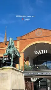 Diners cooking all-you-can-eat Korean BBQ & hotpot with meats, seafood, and sushi at Daiu in Coventry.