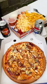 A short vlog-style review of a takeaway shop in Newcastle called Get Stuffed, featuring the creator walking up to the venue, showing the menu, and presenting the food (pizza and parmo with chips) in takeaway boxes.