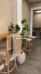 Interior of King Eddie's Coffee, a dog-friendly cafe in North Shields metro station, showing coffee, pastries, and seating.