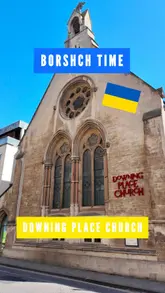 The video is a review of a community event called 'Borshch Time' held at Downing Place Church in Cambridge. It highlights the authentic Ukrainian home cooking available, including borshch, dumplings, sausages, and various desserts, while also showcasing the communal dining atmosphere and the charitable nature of the event.