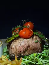 Here are a few options for your alt text, depending on the focus of the image:

**Option 1 (Descriptive):**
A delicious steak dinner with a glass of red wine at a French restaurant.

**Option 2 (Social-focused):**
A gourmet French steak and wine dining experience shared on social media.

**Option 3 (Detailed):**
Rare steak served with a side of wine in an elegant French bistro setting.

**SEO Tip:** Since the caption includes `@le_haricot_`, if this is the name of the restaurant, it is highly recommended to include that in the alt text (e.g., "Gourmet steak dinner at Le Haricot French restaurant").