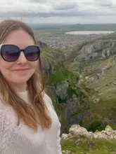 A selfie taken by a creator at the top of Cheddar Gorge, showcasing the scenic landscape and hiking trail.