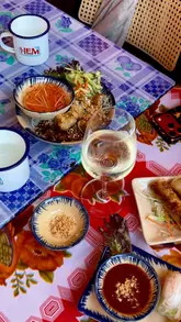 A short montage showcasing a variety of Vietnamese dishes including summer rolls, spring rolls, crispy roast duck, and bun cha, alongside glimpses of the restaurant's interior decor.