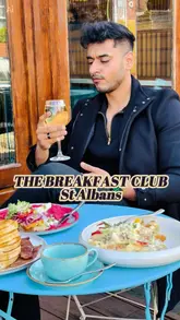 Here are a few options for your SEO alt text, depending on what is most prominent in the photo:

**Option 1 (Focus on the food - best for SEO):**
"A stack of maple-dripping pancakes and a Big American Breakfast at The Breakfast Club in St Albans." (99 characters)

**Option 2 (Focus on the aesthetic/vibe):**
"Delicious brunch spread with waffles, chicken, and French toast at The Breakfast Club restaurant in St Albans." (109 characters)

**Option 3 (Comprehensive):**
"Indulgent brunch plates including pancakes and chicken and waffles at The Breakfast Club, St Albans." (99 characters)

**SEO Tip:** Since you included the location in your caption, keeping "The Breakfast Club" and "St Albans" in the alt text helps local SEO significantly!