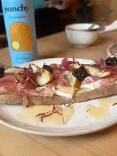 Here are a few options for your SEO alt text, depending on what the specific image shows:

**Option 1 (Focus on the food - best for general use):**
Gourmet sourdough toast with prosciutto, brie, hot honey, and blackberries served at ETE Westbourne brunch cafe.

**Option 2 (Focus on the lifestyle/vibe):**
A delicious brunch spread with iced lattes and artisan toast at ETE Westbourne coffee shop.

**Option 3 (Descriptive and SEO-friendly):**
Fresh sourdough toast with wild mushrooms and seasonal toppings at ETE Westbourne, a popular brunch spot.

**Tip:** Choose the one that best describes the specific visual content of your photo (e.g., if it's the mushrooms, use option 3; if it's the brie toast, use option 1).