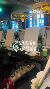 A vlog-style video showcasing a 'sip and paint' event held at a Slug & Lettuce venue. The video follows the creator through the process of painting a forest scene, highlighting the social atmosphere, the step-by-step instruction, and the final results of the participants.