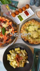Here are a few options for your alt text, depending on what is most prominent in the image:

**Option 1 (Focus on the spread/feast):**
A colorful Italian feast featuring pizza, pasta, arancini, and cocktails at PrimaVista restaurant in Bath.

**Option 2 (Focus on the restaurant/vibe):**
A table full of delicious Italian dishes including pizza and pasta at the new PrimaVista restaurant on Quiet St, Bath.

**Option 3 (Detailed focus):**
A spread of Italian food at PrimaVista, Bath, featuring La G pizza, 5P rigatoni, arancini, and a lemon sorbet dessert.

**SEO Tip:** Alt text should describe the visual content while naturally including the primary keywords (PrimaVista, Bath, Italian food). All of the above options are under 125 characters.