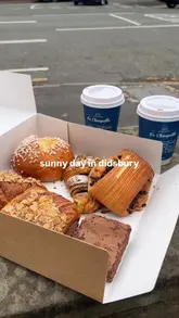 A short, aesthetic montage capturing a sunny day in Didsbury, featuring visits to a local bakery and a coffee stall, interspersed with shots of local scenery and flowers.