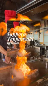 Here are a few options for your SEO alt text, depending on what the photo specifically shows:

**Option 1 (Focus on the experience):**
Chef performing a fire trick at Sapporo Teppanyaki restaurant in Liverpool during a family Sunday lunch.

**Option 2 (Focus on the food/kids):**
Family enjoying an interactive Teppanyaki dining experience with a live cooking show at Sapporo Liverpool.

**Option 3 (Concise & SEO-focused):**
Interactive Teppanyaki cooking experience at Sapporo Teppanyaki restaurant in Liverpool city centre.

**Tip:** If the image is a specific shot (e.g., the chef flipping an egg or lighting the grill), replace "live cooking show" with that specific detail to make the alt text even more descriptive for Google.