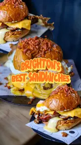 A creator reviews a bacon bap at Embers in Brighton, featuring shots of the chef preparing the dish, the final product, and the creator tasting it. The video is part of a series reviewing sandwiches in the city.