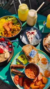 Here are a few SEO-friendly alt text options under 125 characters:

**Option 1 (Descriptive):**
Freshly prepared Buddha bowl and Samosa Chaat served at 50Nine restaurant in St Albans.

**Option 2 (Keyword focused):**
Halal Samosa Chaat and healthy Buddha bowl at 50Nine, a popular brunch spot in St Albans.

**Option 3 (Action-oriented):**
Close up of a vibrant Buddha bowl and smoothie at 50Nine Halal restaurant in St Albans.