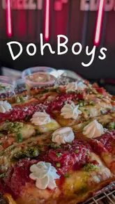 Here are a few options for your SEO alt text, keeping it under 125 characters:

*   **Option 1 (Descriptive):** Delicious Detroit-style pizza with thick cheesy crust and fresh marinara sauce at Doh Boys in Norton, Teesside.
*   **Option 2 (Action-focused):** A close-up of a cheesy Detroit-style pizza served at the new Doh Boys restaurant in Norton, Teesside.
*   **Option 3 (Concise):** Freshly baked Detroit-style pizza featuring a thick, crispy cheese crust from Doh Boys in Norton.