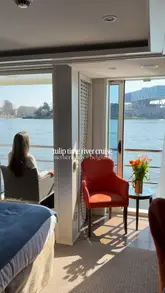 Here are a few options for your SEO alt text, depending on what is actually in the photo:

**Option 1 (Focus on the cruise experience):**
"Traveler enjoying the scenic view of blooming tulip fields from an AmaWaterways river cruise ship in the Netherlands."

**Option 2 (Focus on the destination/tulips):**
"Colorful rows of tulips in full bloom along a scenic waterway during an AmaWaterways river cruise in the Netherlands."

**Option 3 (Lifestyle/Travel advisor focus):**
"A peaceful river cruise journey through Dutch waterways past vibrant tulip fields on a sunny day."

**SEO Tip:** Since alt text is for accessibility and search engines, these options include your main keywords (AmaWaterways, river cruise, tulips, Netherlands) while accurately describing the visual content.