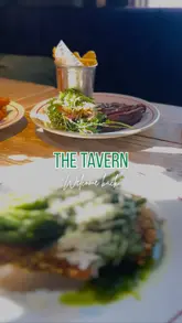 A short montage showcasing a few dishes, including steak with fries and green beans, served at a venue called The Tavern. The video focuses entirely on the food presentation with music and a simple text overlay.