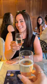 A group of friends visits a Pizza Express for a bottomless brunch event, featuring unlimited drinks, pizza, dough balls, and a live DJ. The video captures the social atmosphere and the dining experience.
